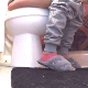 A coughing girl sits down on a toilet, farts, and takes a shit. Soft, but subtle pooping sounds and a fart are heard. Only her feet and legs are seen. A lot of just sitting around after that. Presented in 720P HD. 103MB, MP4 file. About 6.5 minutes.
